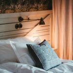 empty bed beside white curtain